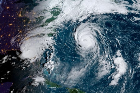 Early morning satellite image of the eastern coast of the United States and the Atlantic Ocean. Hurricane Idalia on the left makes landfall on Florida's coast and Hurricane Franklin sits over the Atlantic near Bermuda