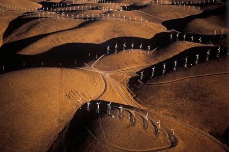 Aerial shot of wind turbines on hilly landscape