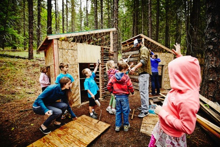 Children build forts in the woods.