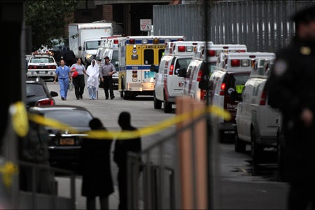 Ambulances surrounding patiend being evacuated from hopsital