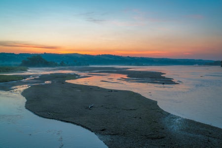 Landscape view of winding river at sunset.